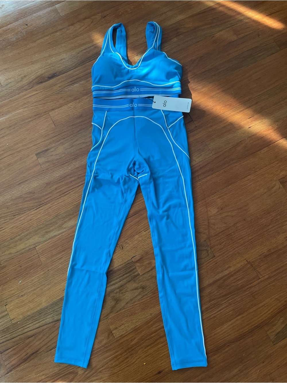ALO Yoga women’s Bright Blue One-Piece Active Bodysuit with White Piping